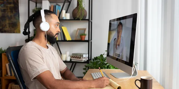 Freelance marketer taking notes during a video call with a client