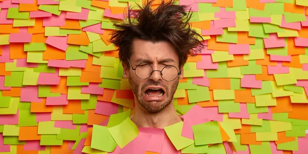 close-up-young-student-surrounded-by-sticky-notes