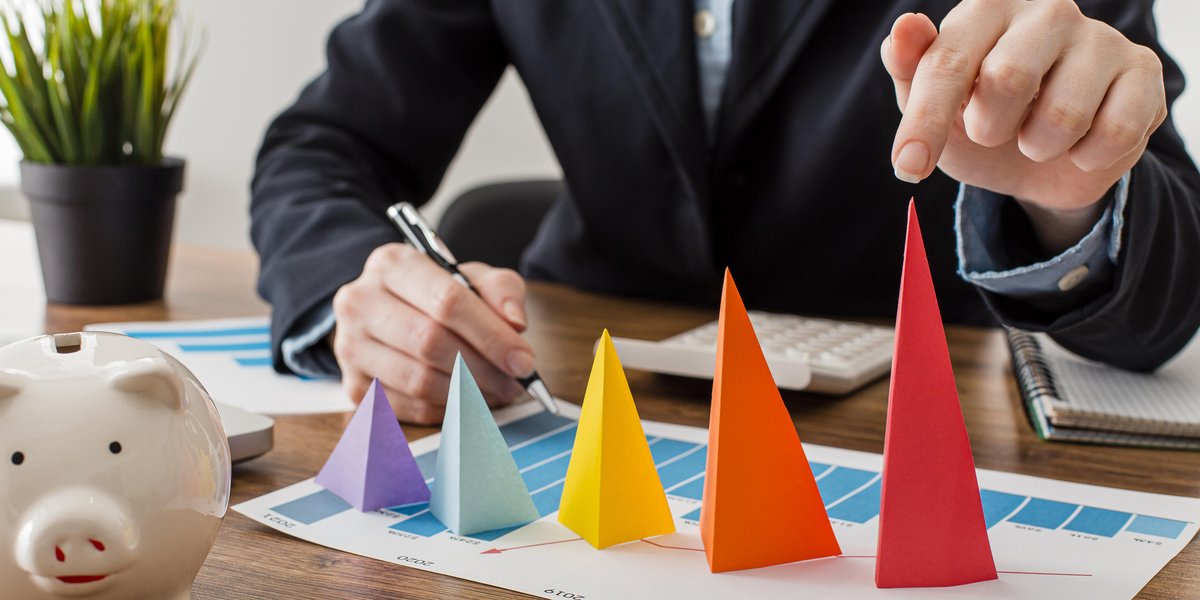 front-view-businessman-with-colorful-cones-representing-growth