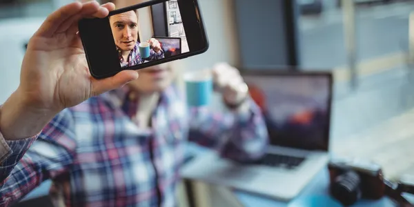 male-executive-taking-selfie-from-mobile-phone