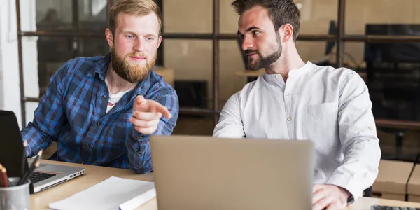 man-pointing-finger-his-colleague-s-laptop-workplace