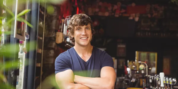 portrait-bar-tender-standing-with-arms-crossed