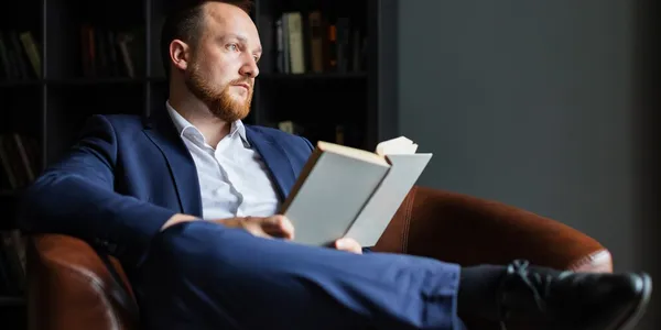 successful-businessman-suit-sits-reading-book-thinks_102583-377